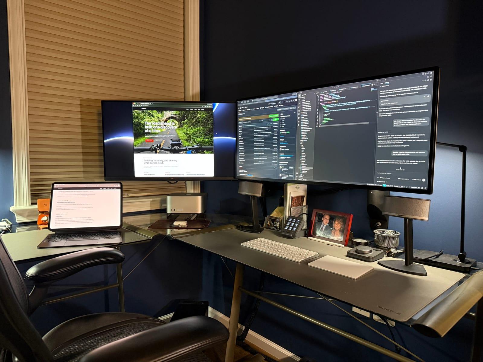 Joe’s home workspace with monitors showing the jthnet website project, code, and an AI conversation.