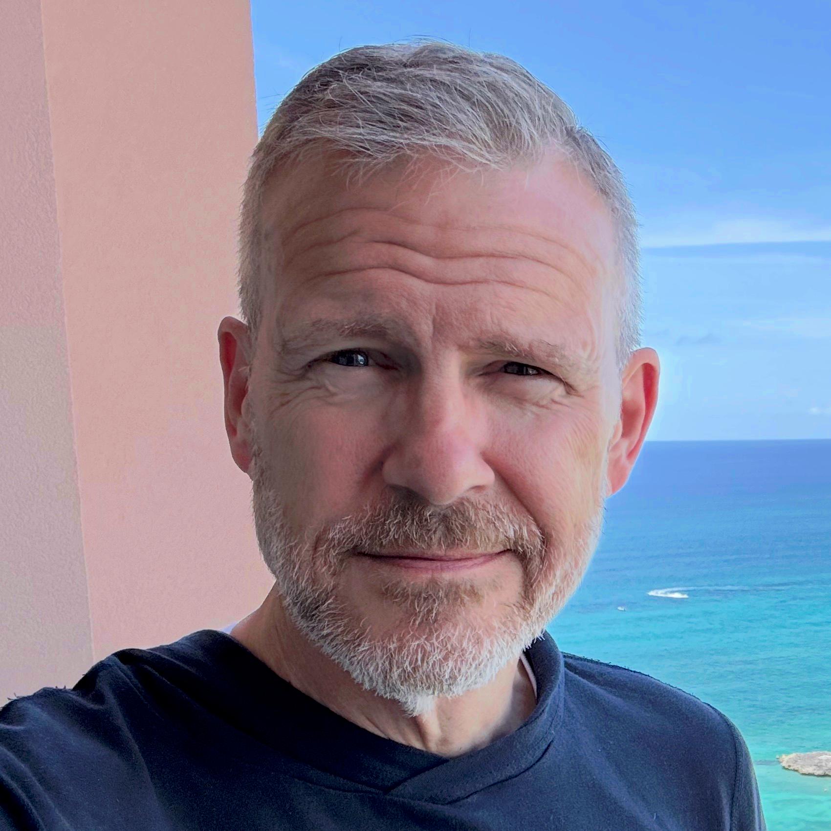Portrait of Joe Hummel with the ocean in the background.